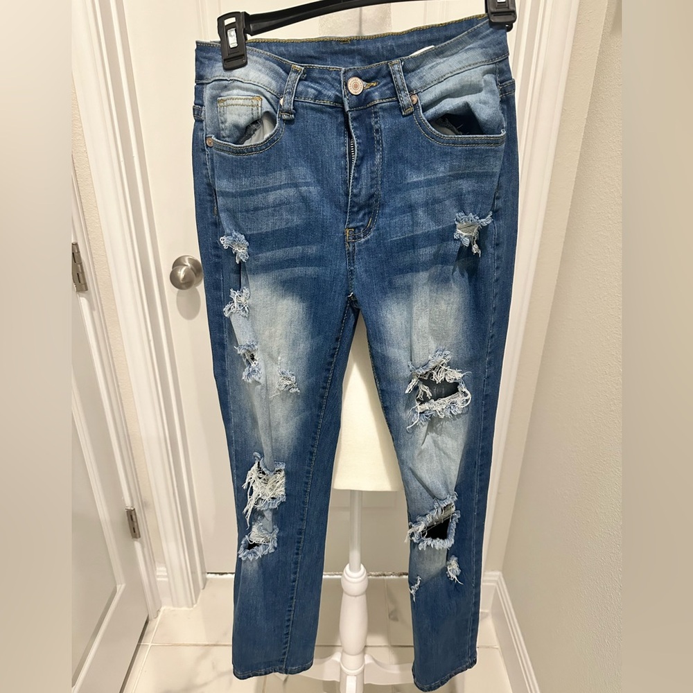 Kunmi ripped light blue skinny jeans.